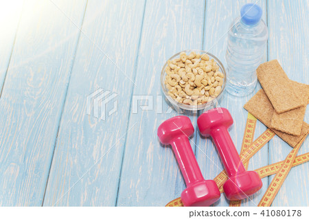 The concept of a healthy diet. Small dumbbells. healthy lifestyle. sport. Fitness food. The concept of a healthy diet. Small dumbbells. healthy lifestyle. sport. Fitness food. 41080178