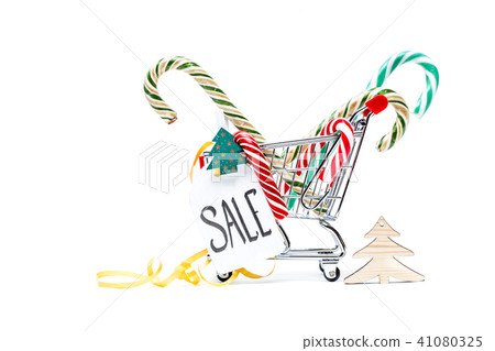 Image of trolley with caramel canes, Christmas tree, greeting card, ribbon Image of trolley with caramel canes, Christmas tree, greeting card, ribbon 41080325