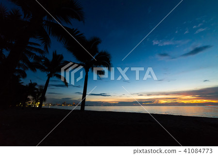 Colorful sunset with coconut palm tree silhouettes Colorful sunset with coconut palm tree silhouettes 41084773