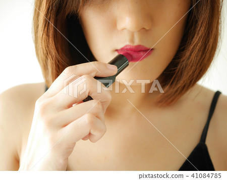 portrait young woman applying or wearing lipstick portrait young woman applying or wearing lipstick 41084785