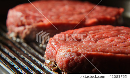 Two Fresh Beefsteaks on a grill Two Fresh Beefsteaks on a grill 41085765