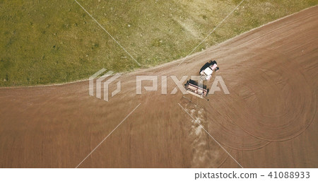 Aerial view of Tractor plowing fields -preparing land for sowing Aerial view of Tractor plowing fields -preparing land for sowing 41088933
