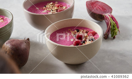 Berry smoothie in a bowl on the breakfast with berries, oatmeal and honey on a stone background 41089362