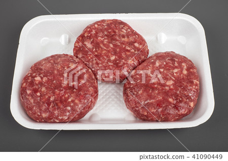 beef burgers in plastic package isolated on white background beef burgers in plastic package isolated on white background 41090449