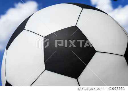 Soccer ball against blue sky with white clouds, texture, for sport background 41097351