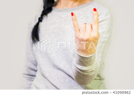 Woman showing rock sign Woman showing rock sign 41098962