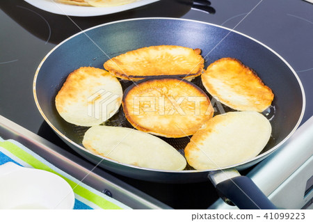 Pancakes on the pan in kitchen 41099223