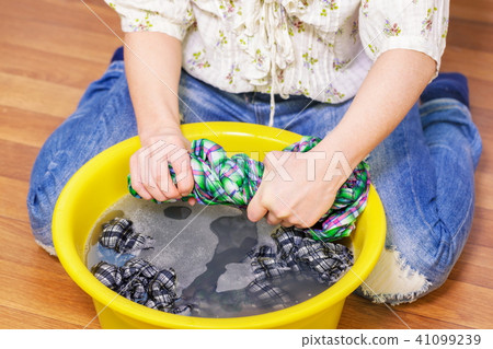 Woman squeeze wet clothes 41099239