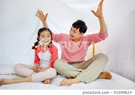 A loving daughter and a caring father playing under the bed covers 41099624