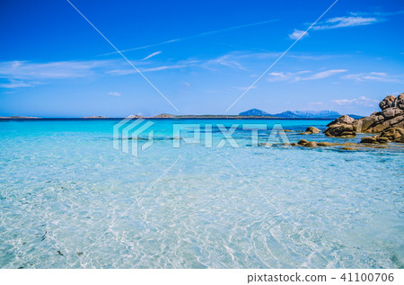 Clear amazing azure coloured sea water with granite rocks in Capriccioli beach, Sardinia, Italy Clear amazing azure coloured sea water with granite rocks in Capriccioli beach, Sardinia, Italy 41100706