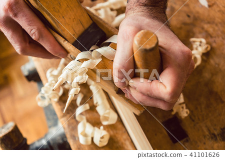 Top view on master carpenter working with wood planer 41101626
