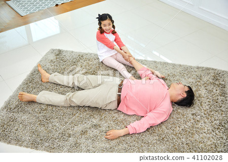 Lovely daughter waking up her napping dad 41102028