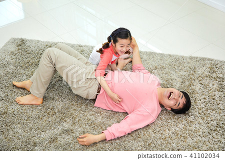 Lovely daughter waking up her napping dad Lovely daughter waking up her napping dad 41102034