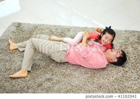 Lovely daughter waking up her napping dad 41102041