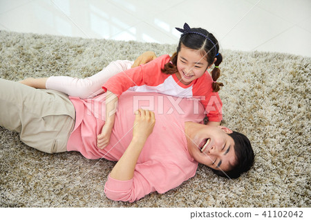 Lovely daughter waking up her napping dad Lovely daughter waking up her napping dad 41102042