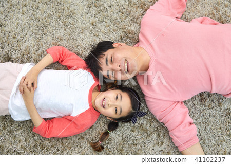 Dad and daughter having a good time lying in the living room Dad and daughter having a good time lying in the living room 41102237