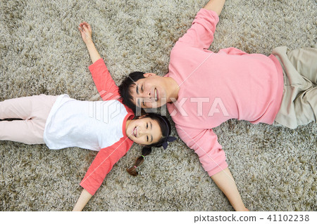 Dad and daughter having a good time lying in the living room Dad and daughter having a good time lying in the living room 41102238