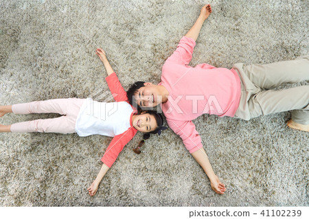 Dad and daughter having a good time lying in the living room Dad and daughter having a good time lying in the living room 41102239