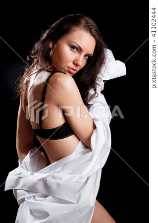 Beautiful woman in black lingerie and white shirt 41102444
