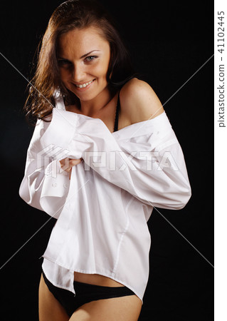 Beautiful woman in black lingerie and white shirt 41102445