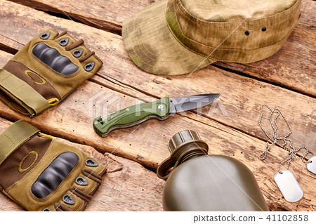 Set of military outfit on wooden background. Set of military outfit on wooden background. 41102858
