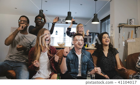 Diverse football fans get wild celebrating win 4K slow motion. Happy multi ethnic friends watching 41104017