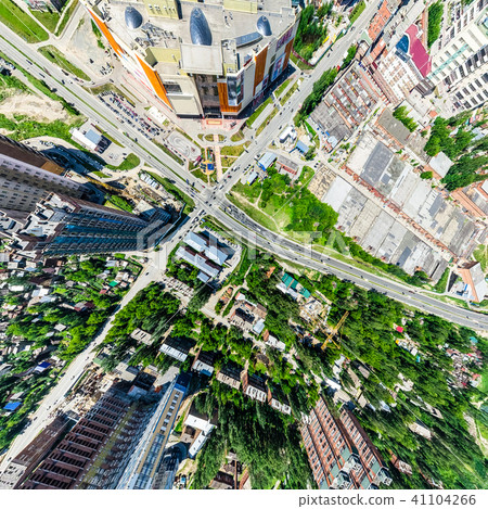 Aerial city view with crossroads and roads, houses, buildings, parks and parking lots. Sunny summer 41104266