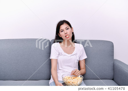 The concept of watching television. Asian girls watching televis The concept of watching television. Asian girls watching televis 41105478