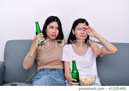 The concept of watching television. Asian girls watching televis 41105480