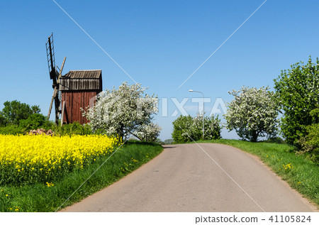 Country road by an old windmill Country road by an old windmill 41105824