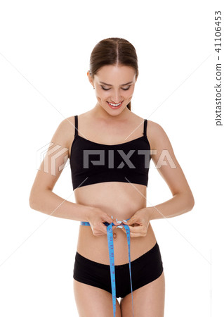 woman measuring waist with blue measuring tape. woman measuring waist with blue measuring tape. 41106453