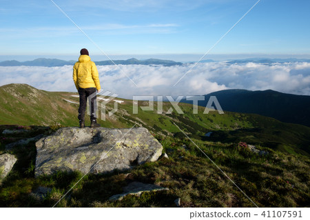 Alone tourist in yellow jacket Alone tourist in yellow jacket 41107591
