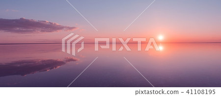 Landscape beautiful golden sunset red sky solt lake saline Elton Baskunchak. The sun sets behind the 41108195