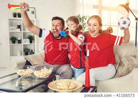 family of fans watching a football match on TV  41108573