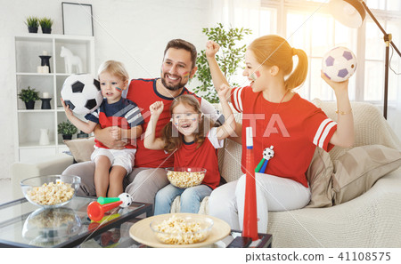 family of fans watching a football match on TV family of fans watching a football match on TV 41108575