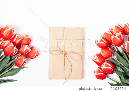Gift box tied with rope among summer red flowers Gift box tied with rope among summer red flowers 41108654