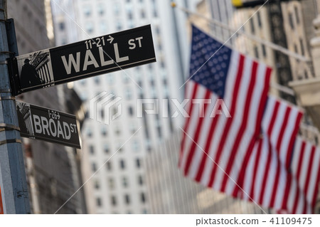 Wall street sign in New York with American flags and New York Stock Exchange background. 41109475