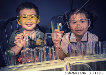 children studying in school science laborator 41111442