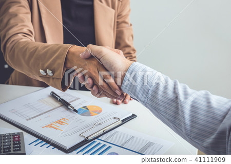 Business partnership meeting concept, Two confident Business han Business partnership meeting concept, Two confident Business han 41111909