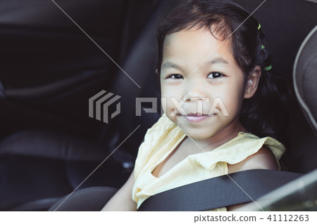asian child girl smiling and sitting in car seat asian child girl smiling and sitting in car seat 41112263
