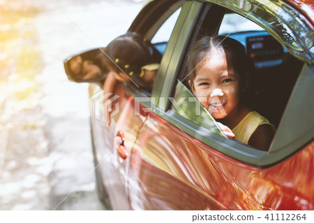 Two cute asian girls smiling and travel by car Two cute asian girls smiling and travel by car 41112264