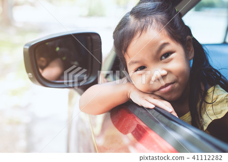 Cute asian little child girl traveling by car Cute asian little child girl traveling by car 41112282