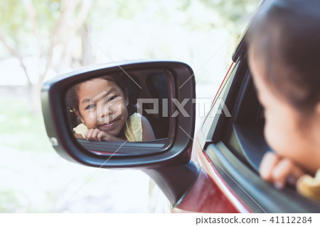 Cute asian little child girl traveling by car Cute asian little child girl traveling by car 41112284