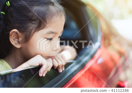 Cute asian little child girl traveling by car Cute asian little child girl traveling by car 41112286