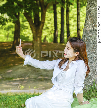 A young female model taking a self-portrait A young female model taking a self-portrait 41112500