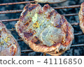 Meat with onions and mustard on the grill 41116850