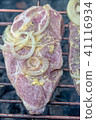 Meat with onions and mustard on the grill 41116934