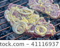 Meat with onions and mustard on the grill 41116937