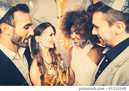 Men and women celebrating party while clinking glasses 41118349