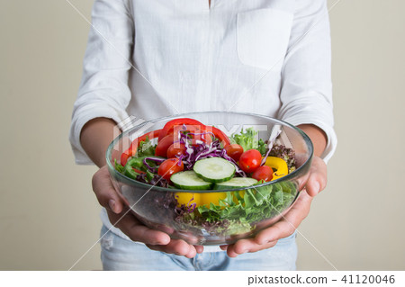 hands of beautiful woman holding big bowl hands of beautiful woman holding big bowl 41120046